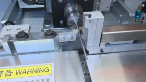Slender ejector pin positioned in an automatic straightening station
